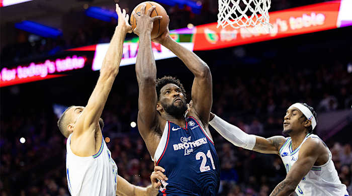 76ers’ Joel Embiid drives to the basket vs. Rudy Gobert, Timberwolves.